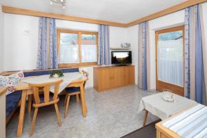 a kitchen and dining room with a table and chairs at Haus Konrad in Reith im Alpbachtal