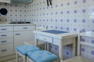 a kitchen with a table and stools in a room at Studio Apartment with Sea View & Fibre Internet in Albufeira