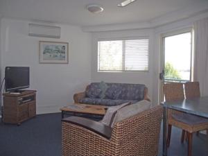 a living room with a couch and a table at River Sands Apartments in Maroochydore