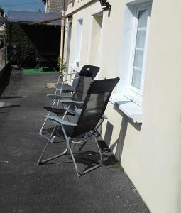 a row of chairs sitting outside of a building at " autour de la Baie " in Pleine-Fougères