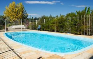a swimming pool in a yard with a fence at Hotel Villa Deifiori in Bento Gonçalves