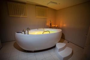 a bathroom with a white bath tub in a room at Zámek Lužec Spa & Wellness Resort in Karlovy Vary