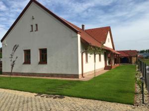 a white house with a red roof at Termálvölgye Vendégház in Demjén
