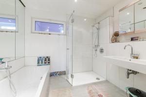 a white bathroom with a shower and a sink at Private Room in Hannover