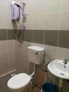 a bathroom with a toilet and a sink at Address No 915, Lorong Uni Central 13, Taman Uni Central, Kuching Samarahan Expressway in Kuching