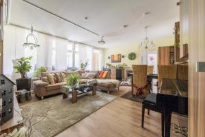 a large living room with a couch and a piano at Private Room in Hannover