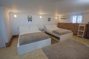 a bedroom with two beds and a brick wall at One Bedroom Chalet managed by Lilly Apartments in Hurghada