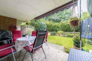 a patio with a table and chairs in a yard at Private Room in Hannover