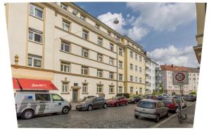 a group of cars parked in front of a large building at Private Room in Hannover