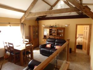 a living room with a couch and a table at Rhydgaled in Llanon