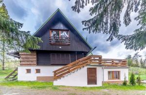 a house with a gambrel roof and a window at Chata Daniela in Dedinky