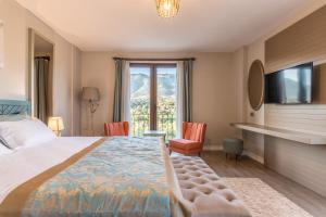 a hotel room with a bed and a large window at Karia Hotel Palamutbükü in Cumalı