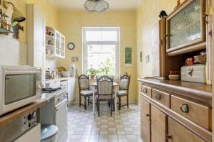 a kitchen with a table and a tv in it at Private Room in Hannover