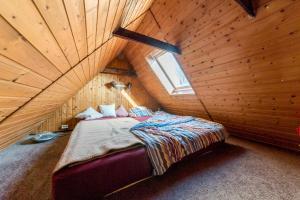 a bed in a room with a wooden ceiling at Private Apartment in Hannover