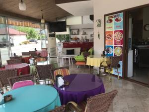 an empty restaurant with tables and chairs and a tv at Murat Apart Hotel in Marmaris