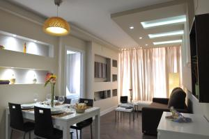 a living room with a table and a dining room at Gaudint Barcelona Suites in Barcelona