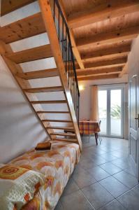 a bedroom with a staircase with a bed and a table at Villa Carmen in Sali