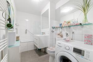 a white bathroom with a washing machine in it at Private Room Laatzen in Hannover
