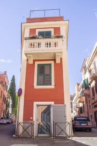 a red and white building with a balcony on it at CasaMia in Rome