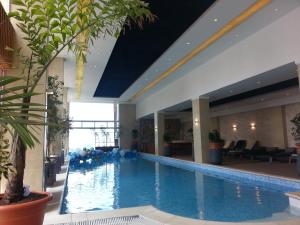 a large swimming pool in a hotel lobby at Grand Eliana Hotel Conference & Spa in Addis Ababa