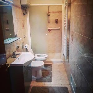 a bathroom with a toilet and a sink and a shower at Central Isernia in Isernia