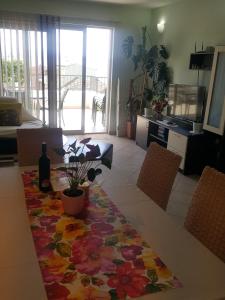 a living room with a table with a bottle of wine at Apartments Pero in Podgora