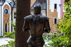 a statue of a woman standing next to a tree at Zámek Lužec Spa & Wellness Resort in Karlovy Vary