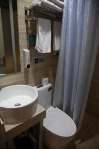 a bathroom with a white toilet and a sink at Shanghai Fish Inn Bund in Shanghai