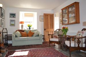 a living room with a couch and a table at Camlann in Alyth