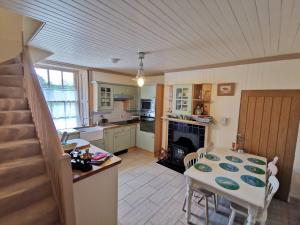 a kitchen and dining room with a table and chairs at Leithen Lodge in Innerleithen