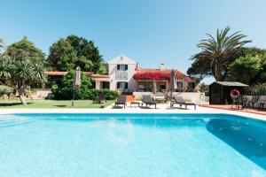 a swimming pool in front of a house at Quinta Verde Sintra - Casa de Campo in Sintra