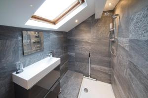a bathroom with a white sink and a shower at Blackbird Luxury Apartments Room 4 in Blackpool