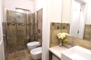 a bathroom with a toilet and a sink and a shower at Casa delle Rocche in Monteu Roero