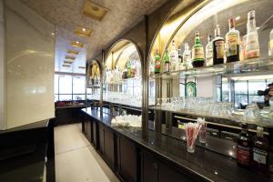 a bar with a lot of bottles of alcohol at Hotel Diplomat Palace in Rimini