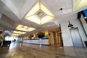 a large lobby with a large lobby with a large ceiling at Hotel Diplomat Palace in Rimini