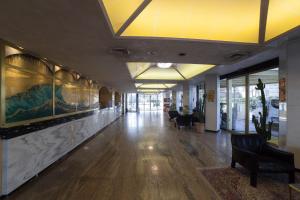 an office lobby with a hallway with desks and chairs at Hotel Diplomat Palace in Rimini +37 photos