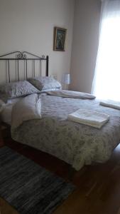 a bedroom with two beds with towels on top at Panoramico Playa de Altar I in Barreiros
