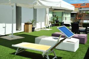 a laptop sitting on a stand on a lawn at Hotel Margherita in Rimini