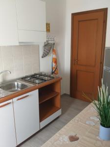 a kitchen with a sink and a stove top oven at La Casa di Zoe - Terre del Magra in Bocca di Magra
