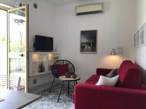 a living room with a red couch and a table at 35G Borgonovo in Pizzo