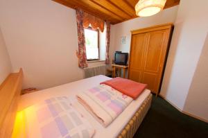 Habitación pequeña con cama y ventana en Gasthof Koglerhof, en Ternberg