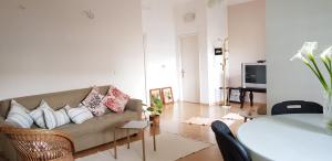 a living room with a couch and a table at Green Villa in Vlorë