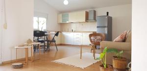 a kitchen with a table and chairs in a room at Green Villa in Vlorë +64 photos