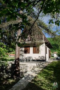 Biały dom ze stołem i drzewem w obiekcie Lodge Zbilje Visoko, Bosnian Pyramids w mieście Visoko