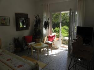 a living room with a bed and a sliding glass door at Villa Ingrid in Saint-Tropez