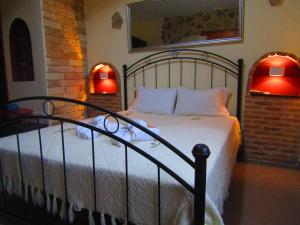a bedroom with a bed with two lights on it at Aristos Apartments & Suites in Stalos
