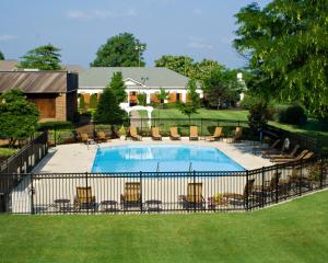 a fence around a swimming pool in a yard at Millennium Maxwell House Nashville in Nashville