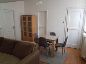 a living room with a couch and a table and chairs at SARA Apartment in Banja Luka