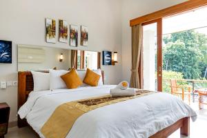 Postel nebo postele na pokoji v ubytování Indah Bali Guesthouse + 37 fotografií
