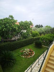 a garden with a staircase and a flower garden at Hotel Patelis in Poulithra